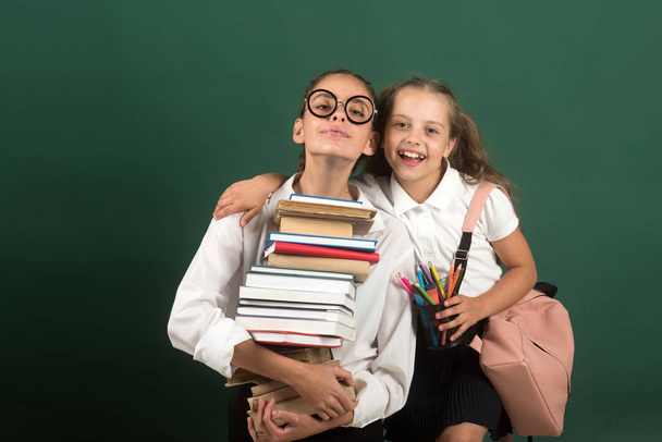 happy childhood of littla girl and her teen sister. happy childhood and back to school concept - Фото, изображение
