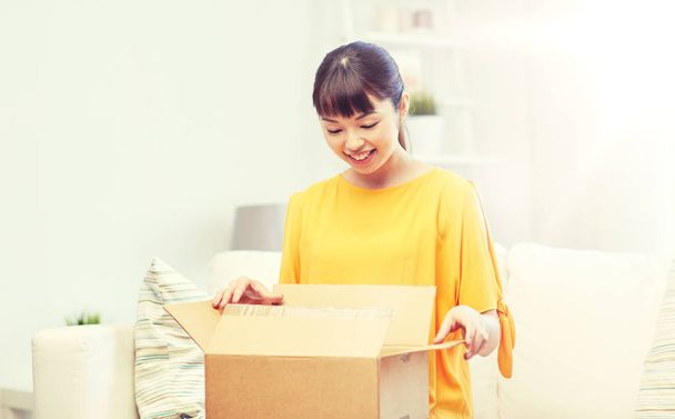 happy asian young woman with parcel box at home - Valokuva, kuva