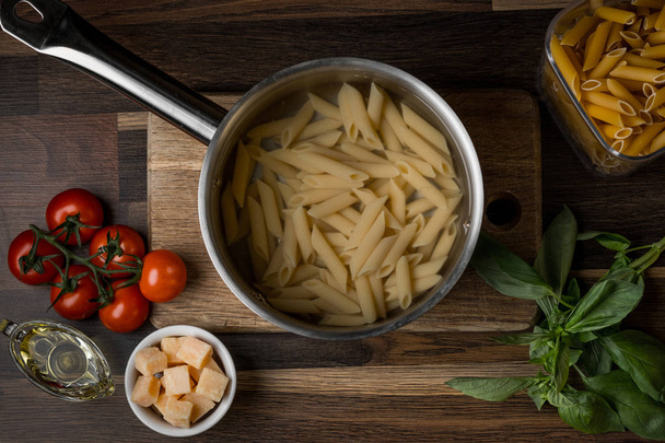 close-up photo of raw pasta in boiled pan background - Zdjęcie, obraz