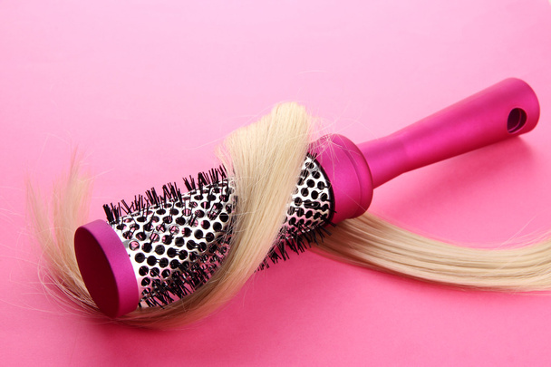 Comb brush with hair, on pink background - Photo, Image