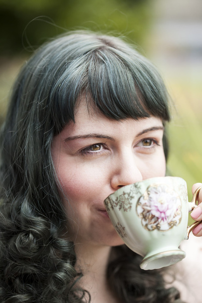 Young Woman with Antique Tea Cup - Fotó, kép