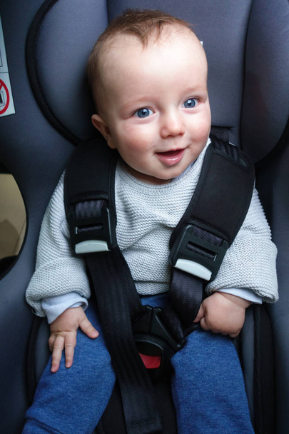 Happy baby jongetje zittend op autostoel - Foto, afbeelding