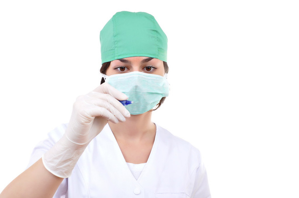 Closeup portrait of young female surgeon pointing at copyspace - Foto, afbeelding