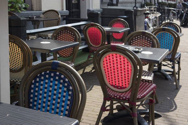 Multicolored wicker chairs in a street cafe. - Photo, image