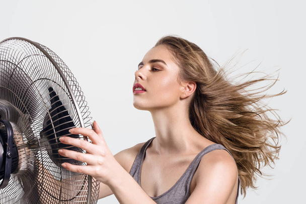 Young woman with cooler fan - Φωτογραφία, εικόνα