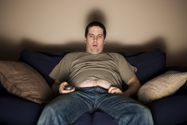 Overweight slob watching TV - Photo, Image