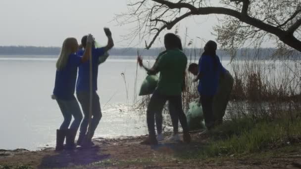 Voluntários alegres comemorando acabamento de limpeza
 - Filmagem, Vídeo