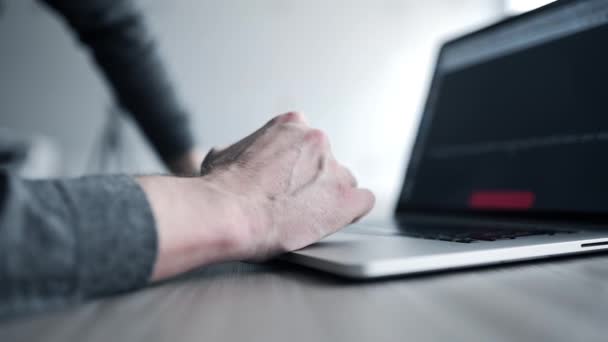 Ο άνθρωπος σε γκρι πουλόβερ σερφάρει στο internet με το laptop του και χρησιμοποιεί μαξιλάρι αφής, σύροντας το touchpad, επανδρώνει τα χέρια χρήση του φορητού υπολογιστή, εσωτερικη των χεριών με το σημειωματάριο, ψάχνει το διαδίκτυο, κοινωνικών μέσων μαζικής ενημέρωσης, e - Πλάνα, βίντεο