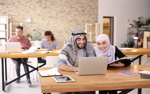 Muslim students in traditional clothes studying indoors - Photo, Image