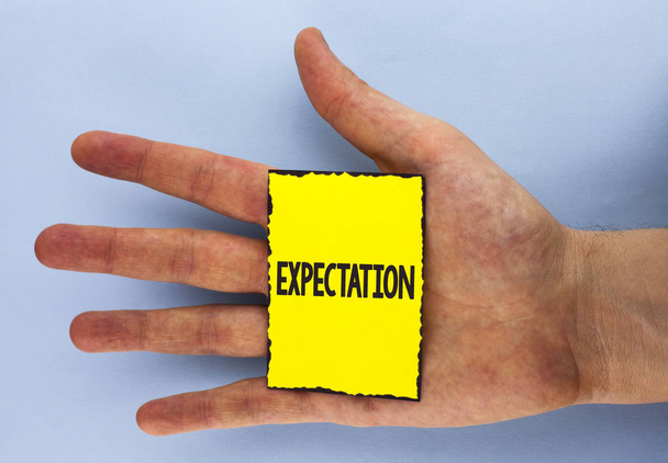 Conceptual hand writing showing Expectation. Business photo showcasing Meteorological research analyst predicts weather forecast written on Yellow Sticky Note Paper on plain background Hand. - Photo, Image
