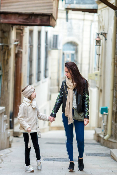 Mother and little daughters outdoor in city - Photo, Image