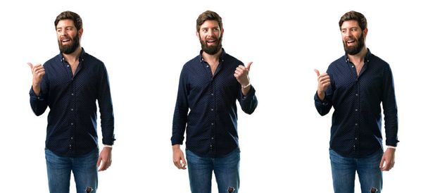 Young man with beard pointing away side with his finger isolated over white background - Photo, Image
