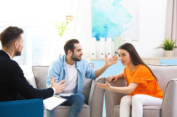 Family psychologist working with young couple in office - Photo, Image