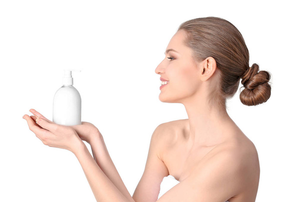Young woman with bottle of hand cream on white background - Foto, Imagen