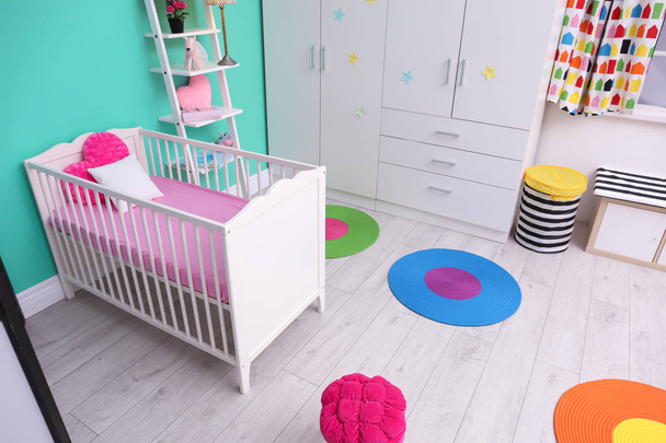 Light baby room interior with crib - Foto, imagen