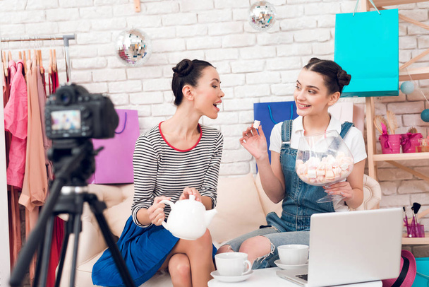Two fashion blogger girls drinking tea with marshmallows to camera - Photo, image