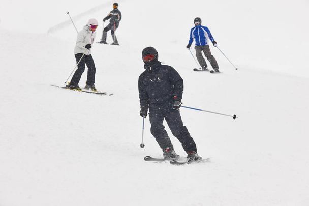 Skiers under the snow. Winter sport. Ski slope - Photo, Image