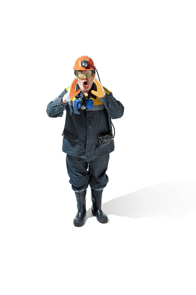The studio shot of senior bearded male miner standing at the camera on a white background. - Fotó, kép