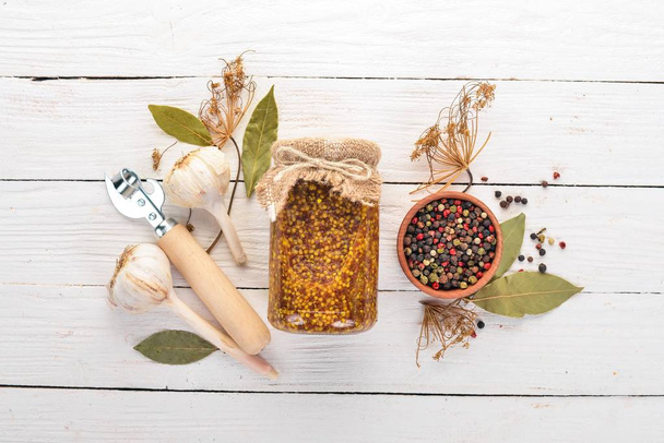 Pickled mustard in a jar. Stocks of food. Top view. On a wooden background. Copy space. - Fotoğraf, Görsel