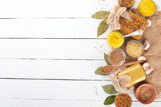 A set of mustard and spice. On a wooden background. Top view. Copy space for your text. - Foto, Imagen