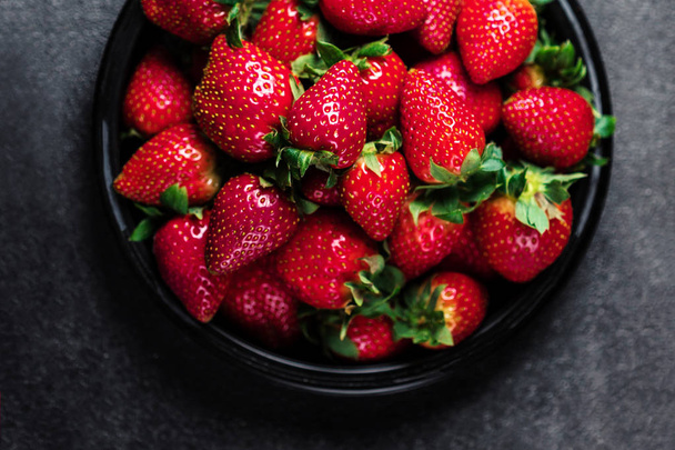 Fresh strawberries on black background with copy space for text. - Photo, Image