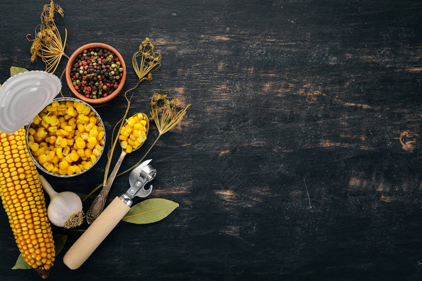 Pickled corn in a jar. Stocks of food. Top view. On a wooden background. Copy space - Foto, afbeelding