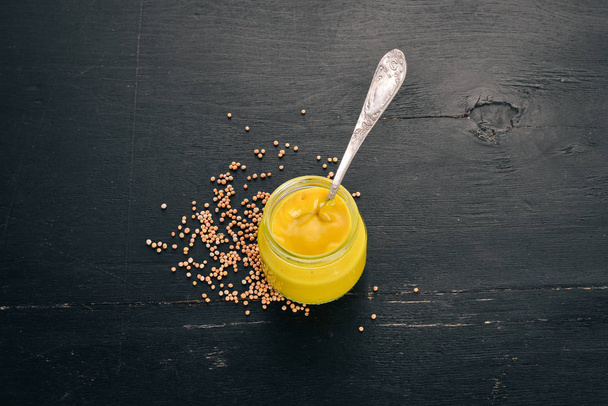 Mustard Sauce. Spices On a black wooden background. Top view. Copy space for your text. - Foto, immagini