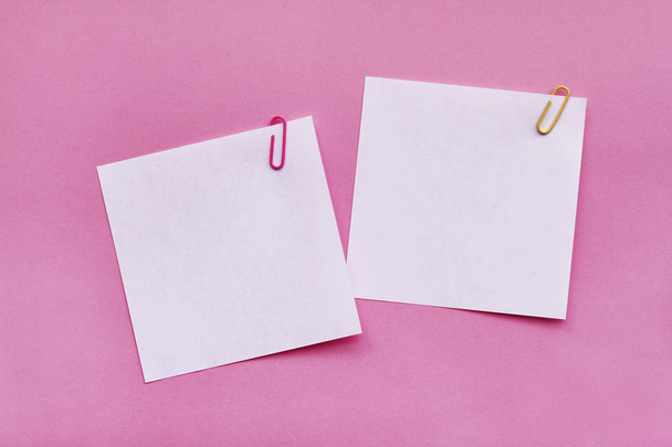 Two white blank note papers with clips on bright pink background - Foto, Imagen