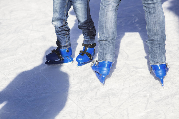 People skating with blue skates  - Photo, Image