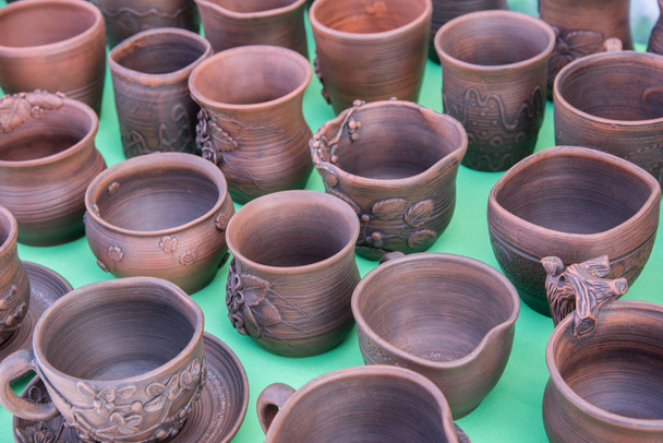 Beautiful pottery mugs of brown color handmade on the market - Photo, Image