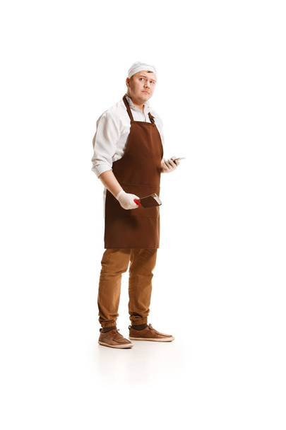 Serious butcher posing with a cleaver isolated on white background - 写真・画像