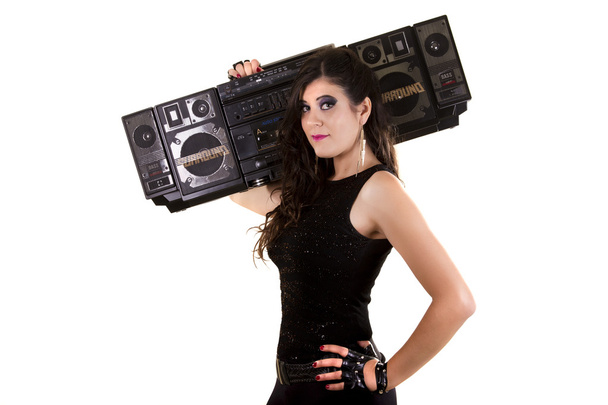 beautiful girl in dark leather clothes holding a large retro radio - Photo, Image