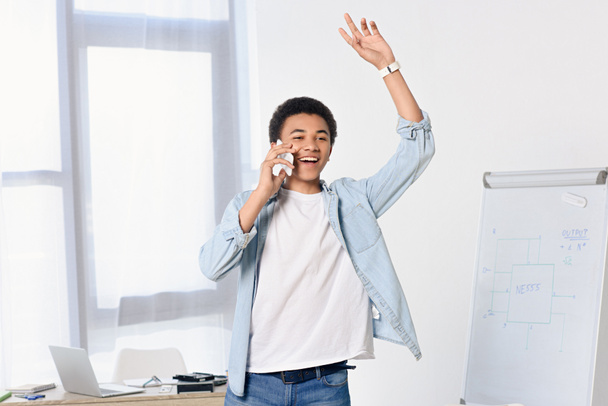 african american teenager talking by smartphone and waving hand at home - Photo, Image