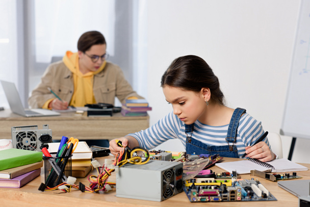 teenagers studying and fixing computer motherboard at home - Zdjęcie, obraz