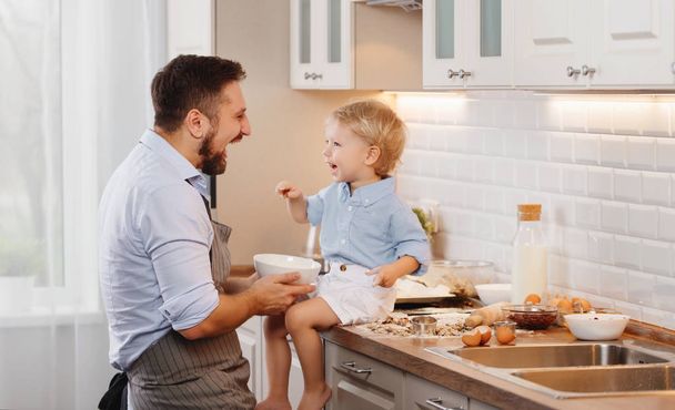 happy family in kitchen. father and child son baking cookies together - Photo, Image