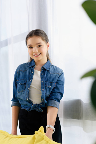 portrait of smiling preteen child looking at camera at home - Foto, Imagen