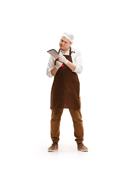Bored butcher posing with a cleaver isolated on white background - Valokuva, kuva