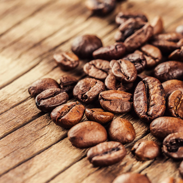 roasted coffee beans on wooden background - Фото, изображение