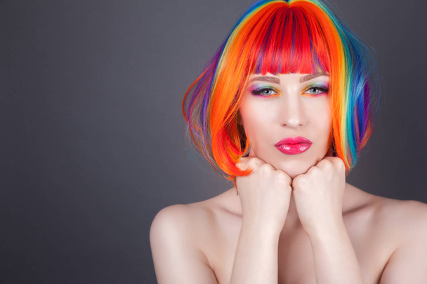 beautiful woman wearing colorful wig and showing colorful nails  - Foto, Bild