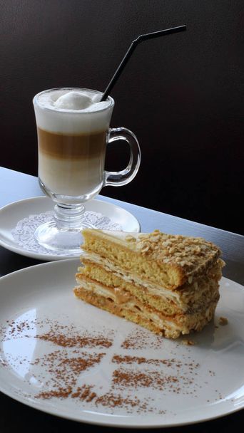 Dessert mit süßem Napoleonkuchen und Sahnekaffee aus nächster Nähe auf dem Tisch serviert  - Foto, Bild