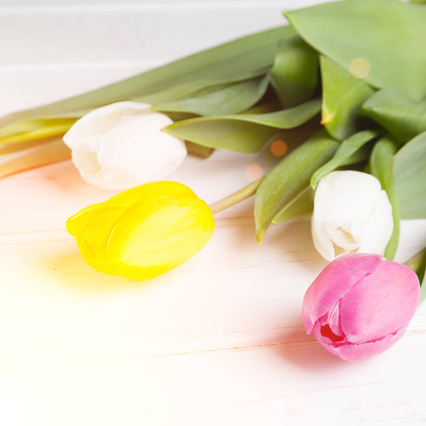 bouquet of purple, yellow and white tulips on a wooden background - Fotografie, Obrázek