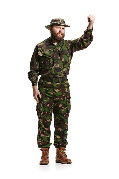 Young army soldier wearing camouflage uniform isolated on white - 写真・画像