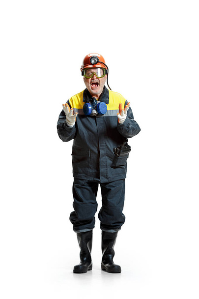 The studio shot of senior bearded male miner standing at the camera on a white background. - Foto, Bild