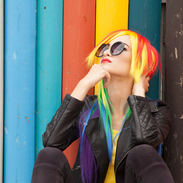 beautiful young woman wearing color wig and sunglasses - Фото, изображение