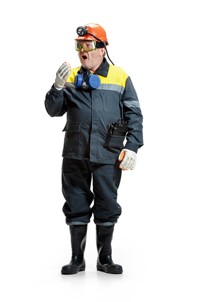 The studio shot of senior bearded male miner standing at the camera on a white background. - Foto, imagen