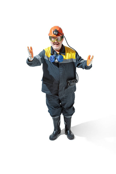 The studio shot of senior bearded male miner standing at the camera on a white background. - Foto, imagen