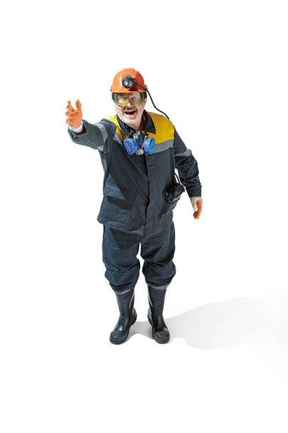 The studio shot of senior bearded male miner standing at the camera on a white background. - Фото, зображення