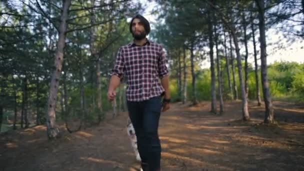 man walking with siberian husky dog in forest - Filmagem, Vídeo