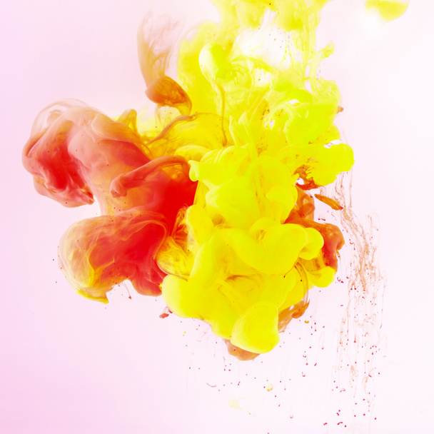 texture with flowing yellow and red paint swirls on pink - Foto, imagen