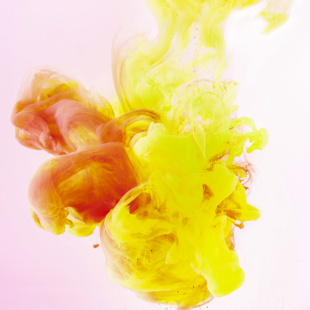 artistic background with flowing yellow and red paint on pink - Fotografie, Obrázek
